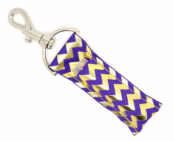Regal Radiance Purple & Gold Chevron Lip Balm Holder

Channel your inner royalty with Regal Radiance—a stunning lip balm holder featuring a rich purple background accented with bold, shiny gold foil chevron stripes. It’s the perfect balance of elegance and flair, keeping your lip balm handy while turning heads.

Whether you’re headed to class, work, or a night out, this posh holder is a stylish must-have for queens of convenience and fans of glam.

Why You’ll Love It:
Striking purple & gold foil chevron combo
Holds standard lip balms and chapsticks, and more
Strong silver lobster clasp attaches to keys, purses, backpacks
Handmade with high-quality printed fabric
Great gift for glam lovers and purple fanatics
Product Details:

Design: Purple background with shiny gold foil chevron

Material: High-quality printed fabric

Clip: Silver lobster clasp

Fits: Standard lip balm tubes (not included)

Includes: 1 Regal Radiance lip balm holder

Handmade by Gettin Lippy in the USA