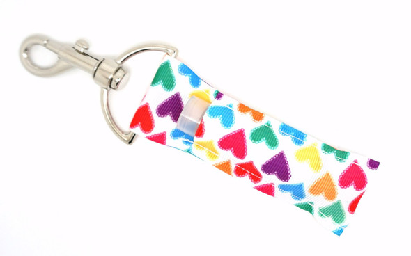 Heart Full of Color Lippy Clip | Rainbow Heart Lip Balm Holder

Say hello to your new happy place! The Heart Full of Color lip balm holder is a joyful celebration of all things bright and beautiful. With a crisp white background covered in vibrant red, orange, yellow, green, blue, purple, and pink hearts, this lippy clip bursts with cheerful energy.

Perfect for anyone who loves rainbows, positivity, and keeping their lip balm within easy reach, this is your everyday essential with a colorful twist!

Why You’ll Love It:
Bright rainbow heart design for a pop of personality
Attaches to your keys, bag, or backpack with ease
Keeps your lip balm clean, secure, and always handy
Makes a thoughtful gift for friends, teachers, or yourself
Made from high-quality printed fabric for long-lasting flair
Product Details:

Design: White background with scattered rainbow-colored hearts

Material: High-quality printed fabric

Clip: Strong silver lobster clasp

Fits: Standard-size lip balm tubes

Includes: 1 Heart Full of Color lip balm holder (lip balm not included)

Handmade by Gettin Lippy in the USA