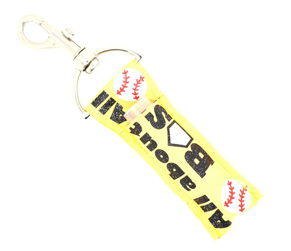 Base Hit Bliss – Baseball Lip Balm Holder Keychain with Fun Quote

Swing for the fences with Base Hit Bliss, the perfect blend of sporty style and lip balm convenience. Featuring a vibrant yellow background with baseballs and the playful phrase “It’s All About That Base,” this lippy clip is a home run for players, fans, and baseball moms alike.

Slide it onto your keychain, bag, or belt loop and keep your chapstick close — on or off the field.

Why You’ll Love It:

Bold Baseball Design – Bright yellow with detailed baseball graphics
Fun Phrase – “It’s All About That Base” adds personality and flair
Clip & Carry – Attaches easily to bags, backpacks, or key rings
Great Gift – Perfect for coaches, team moms, or baseball lovers

Product Details:

Design: Yellow with printed baseballs and the phrase “It’s All About That Base”

Material: High-quality printed fabric

Clip: Silver key ring

Size: Fits most standard lip balm or essential oil rollers

Includes: 1 Base Hit Bliss lip balm holder (lip balm not included)

Handcrafted by Gettin Lippy in the USA