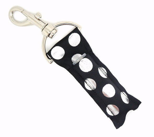 Dot After Dark – Black & Silver Foil Polka Dot Lip Balm Holder Keychain

Add a pop of playful glam to your everyday routine with Dot After Dark. This striking lippy clip features a bold black backdrop adorned with oversized silver foil polka dots that shimmer with every step. Whether you're heading to the office or out for the night, this stylish chapstick holder keeps your lip balm close—and your style on point.

Why You’ll Love It:
Stylish Contrast – Black and silver foil polka dots make a bold statement
Lippy Clip Convenience – Easily clips onto bags, keys, or backpacks
Great Gift Idea – Chic, fun, and functional for any age
Handmade Quality – Made with high-quality printed fabric
Product Details:

Size: Approx. 6.5" x 1.5"

Material: High-quality printed fabric

Includes: 1 Dot After Dark lip balm holder (lip balm not included)

Handmade with love by Gettin Lippy in the USA