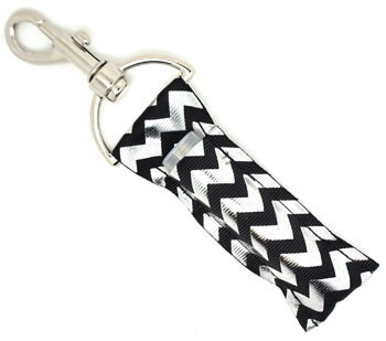 Midnight Gleam – Black & Silver Foil Chevron Lip Balm Holder Keychain

Step into sleek sophistication with Midnight Gleam, the ultimate lippy clip for those who love bold glam with a modern twist. This striking lip balm holder features a deep black background enhanced by shimmering raised silver foil chevrons that catch the light with every move. Whether you're dressing up or keeping it casual, this accessory adds just the right touch of sparkle to your routine.

Why You’ll Love It:

Elegant Design – A classy black base with radiant silver foil chevron
Lippy Clip Functionality – Easily attaches to your bag, keyring, or lanyard
Perfect Gift – Ideal for stylish friends, coworkers, or teens
Handmade Quality – Crafted from high-quality printed fabric for daily durability

Product Details:

Size: Approx. 6.5" x 1.5"

Material: High-quality printed fabric

Includes: 1 Midnight Gleam lip balm holder (lip balm not included)

Handmade with love by Gettin Lippy in the USA