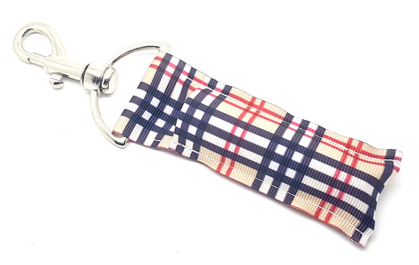 Timeless Tartan – Classic Plaid Lip Balm Holder Keychain

Elevate your everyday essentials with the sophisticated charm of the Timeless Tartan lip balm holder. Featuring a chic plaid pattern in warm tan, bold black, crisp white, and pops of red, this classic design is perfect for anyone who loves understated elegance with a fashion-forward twist. Made from durable material, it keeps your lip balm handy in style—clip it to your keys, purse, or backpack!

Why You’ll Love It:

Classic Chic – Fashion-inspired plaid in timeless neutral tones

Always Handy – Never dig in your bag for lip balm again

Everyday Elegance – Complements any purse or keychain

Perfect Gift – Ideal for stylish friends and family

Product Details:

Size: Approx. 6.5" x 1.5"

Material: Soft, durable style fabric

Includes: 1 Timeless Tartan lip balm holder (lip balm not included)

Handmade in the USA