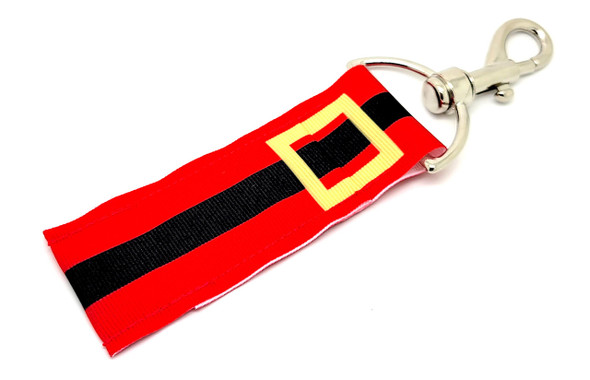 Santa’s Stash – Festive Belted Lip Balm Holder

Bring a little ho-ho-ho wherever you go! Our Santa’s Stash lip balm holder features a merry red background accented by Santa’s iconic black belt and gold buckle running across the center. It’s a jolly way to keep your favorite lip balm secure and accessible all season long.

Perfect as a stocking stuffer, Secret Santa gift, or just a little holiday cheer for yourself!

Why You'll Love It:

Holiday Cheer On-the-Go
The perfect companion for December errands, parties, and cozy nights.

Bold, Iconic Santa Design
Classic red, black, and gold colors with a recognizable festive belt motif.

Easy to Carry
Attach it to bags, purses, keyrings, or even Christmas stockings!

Product Details:

Size: Approx. 6.5" (including clip) x 1.5"

Material: Durable fabric with Santa belt print

Includes: 1 Santa’s Stash lip balm holder

Note: Lip balm not included

Proudly handmade in the USA