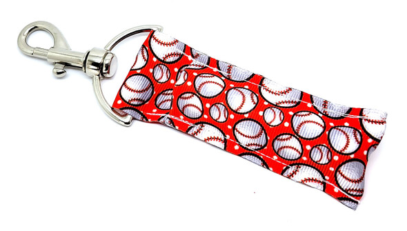 Home Run Red – Baseball Lip Balm Holder

Slide into style with our Home Run Red lip balm holder! This sporty essential features a vibrant red background with classic white baseballs, complete with signature red stitching. It’s the perfect chapstick keychain for baseball fans, players, and little league champs.

Whether you're hitting the field or watching from the stands, keep your lip balm within reach — no more cracked lips during 7th inning stretch!

Why You'll Love It:

Baseball All Day
A fun and bold design that shows off your love for America’s favorite pastime.

Perfect Game Day Accessory
Great for players, coaches, and baseball moms alike.

Portable Convenience
Keychain clip easily attaches to bags, belt loops, or keys.

Product Details:

Size: Approx. 6.5" (including clip) x 1.5"

Material: Red fabric with printed white baseballs and red stitching

Includes: 1 Home Run Red lip balm holder

Note: Lip balm not included

Handmade in the USA