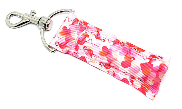 Love & Flamingle – Watercolor Flamingo & Hearts Lip Balm Holder

Fall in love with our Love & Flamingle Lip Balm Holder — a romantic blend of charm and functionality! This sweet design features whimsical watercolor flamingos and hearts in dreamy shades of pinks and reds. It's a heartwarming way to keep your favorite lip balm close and your style even closer.

Whether you're treating yourself or gifting a loved one, this adorable holder is the perfect accessory to carry a little love everywhere you go.

Why You'll Love It:

Romantic, Playful Design
Soft watercolor flamingos and hearts evoke sweet, stylish vibes — perfect for Valentine’s Day, anniversaries, or every day.

Clip & Go
Durable swivel clasp lets you attach your balm to keys, backpacks, purses — never dig through your bag again!

Handmade with Heart
Crafted in the USA using quality fabric and hardware — each one made with care and love.

A Perfect Gift
Great for:

Valentine’s Day

Galentine’s gifts

Animal lovers

Teachers & teens

Just because!

Satisfaction Guaranteed
Not in love? We offer a no-questions-asked Money-Back Guarantee.

Product Details:

Size: 6.5 inches (including clasp) x 1.5 inches

Material: Premium woven fabric + sturdy hardware

Includes: 1 Love & Flamingle Lip Balm Holder

Note: Lip balm not included — pair it with Gettin’ Lippy 3-layer balms!

Handmade in the USA