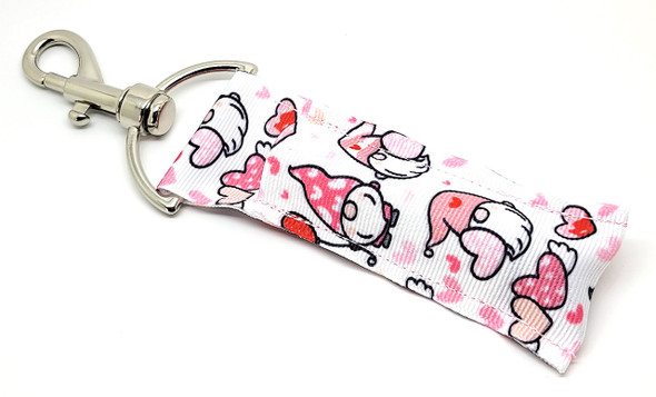 OH My Gnome Lip Balm Holder – Adorably Sweet & Full of Love!

Say hello to your new favorite lip balm accessory! The Oh My Gnome Lip Balm Holder is bursting with cuteness, featuring a white background covered in sweet little gnomes, hearts, and cozy Valentine vibes. Their hats are sprinkled with hearts and the color palette includes dreamy white, red, pink, and soft grey tones—making this the perfect gift for yourself or someone special.

Clip it onto your keys, purse, or bag and keep your favorite lip balm close, cozy, and totally adorable!

Why You’ll Love It:
Never Lose Your Lip Balm Again

Always have your lip balm handy! Our swivel clip makes it easy to attach this holder to your bag, lanyard, or keys—no more digging at the bottom of your purse.

Gnome-tastic Design

These charming little gnomes with heart-covered hats are the ultimate symbol of love and fun. Whether you're celebrating Valentine’s Day or just love cute accessories, this one’s for you!

Handmade Quality

Lovingly handcrafted in the USA using high-quality materials for a snug fit and lasting use. Each one is made with care—just like Grandma’s cookies.

Perfect Gift For:

Valentine’s Day

Galentine’s Parties

Friends, Kids, Teachers & Coworkers

Gnome Collectors

Anyone who loves cute & cozy accessories!

Buy With Confidence

Gettin Lippy’s holders are top-rated for quality and cuteness! Backed by a 100% Money-Back Guarantee, so you can shop stress-free.

Product Details:

Dimensions: 6.5 inches (with hook) x 1.5 inches

Includes: 1 “Oh My Gnome” Lip Balm Holder

Note: Lip balm not included—pair it with one of our custom-flavored balms for the full Gnome Glow-Up!

Handmade in the USA – Add some gnome love to your everyday carry!