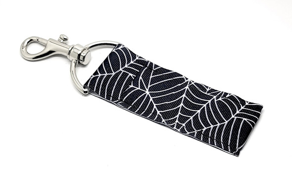 Black Spider Web Lip Balm Holder – Creepy, Cool & Functional!

Spook up your essentials with our Black & White Spider Web Lip Balm Holder! This sleek black holder features intricate white spider webs crawling across the fabric, giving it just the right mix of spooky and stylish.

Perfect for Halloween season—or year-round if you’re all about those spooky vibes—this holder keeps your lip balm handy, hauntingly adorable, and never lost again. Clip it to your bag, keys, lanyard, or backpack and stay webbed into your must-have accessory!

Why You’ll Love It:
No More Lost Lip Balm

With a secure swivel clasp, this holder attaches easily to your keys, purse, or backpack so your lip balm is always within reach.

Sleek & Spooky Style

The black background with bright white spider web print gives off cool Halloween energy while still being subtle enough to rock anytime.

Handmade in the USA

Made with quality stitching and durable materials, this holder is built to last and handmade with love.

Perfect For:

Halloween gifts & boo baskets

Everyday spooky fashion

Party favors & trick-or-treat swaps

Goth-inspired accessories

Teen gifts, coworkers, teachers & friends

Lip balm lovers who love a dark aesthetic

Buy With Confidence

Gettin’ Lippy Lip Balm Holders are top-rated for design, durability, and adorable practicality. Backed by our 100% Money-Back Guarantee, we’re here to make sure you love your purchase—no tricks, just treats!

Product Details:

Dimensions: 6.5 inches (with clasp) x 1.5 inches

Includes: 1 Black Spider Web Lip Balm Holder

Note: Lip balm not included. Check out our multi-flavored lip balms for the ultimate spooky pair-up!

Handmade in the USA – Catch this creepy-cute essential before it disappears into the shadows!