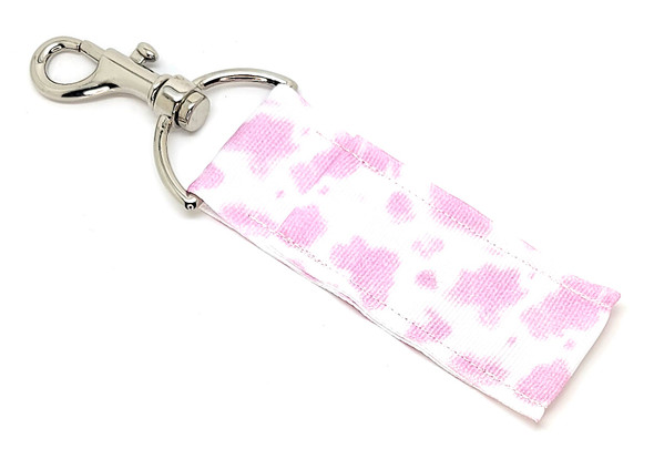 Moo-ve Over Ordinary – Meet the Pink Cow Print Lip Balm Holder!

Bring a little sass and a whole lot of style to your everyday essentials with our Pink Cow Print Lip Balm Holder! This one-of-a-kind accessory features a gorgeous pink background splashed with bold white cow print spots for the ultimate mix of western flair and feminine fun.

Whether you're wrangling your keys, juggling your bag, or trying to keep track of your favorite Gettin' Lippy balm, this holder’s got your back (and your balm). Cute, quirky, and handcrafted with love in the USA, it’s a must-have for anyone who wants their accessories to moove with style.

Why You’ll Love It
Never Lose Your Lip Balm Again

Gone are the days of digging through your bag for your balm! Clip it to your keys, purse, backpack, lanyard—or saddlebag, cowgirl—so your lips stay luscious and moisturized on the go.

Fun & Stylish Design

Pink. Cow print. Enough said. It's flirty, it's fabulous, and it's unlike anything else out there. You'll be the only one in the room with a lip balm holder this adorable.

Handmade in the USA

Each holder is crafted with care to ensure quality and durability. We don’t just make cute stuff—we make it last.

Perfect Gift or Personal Treat

Looking for something unique for:

Birthday party favors

Cowgirl bachelorette parties

Rodeo queens

Teen stocking stuffers or Easter basket fillers

Teacher appreciation gifts

Just because you love cow print? (Same.)

This lip balm holder is guaranteed to add a pop of personality to any day.

Buy With Confidence

We’re proud of our quality—and we back it up. If you’re not totally obsessed with your Pink Cow Print Lip Balm Holder, we offer a 100% Money-Back Guarantee. No questions asked.

Product Details

Dimensions: 6.5 inches (with hook) x 1.5 inches

Includes: 1 Pink Cow Print Lip Balm Holder

Note: Lip balm not included. Pair with any of our Gettin’ Lippy multi-flavored balms to complete the look!

Handmade in the USA 

Order yours now and show the world your wild side—in pink!