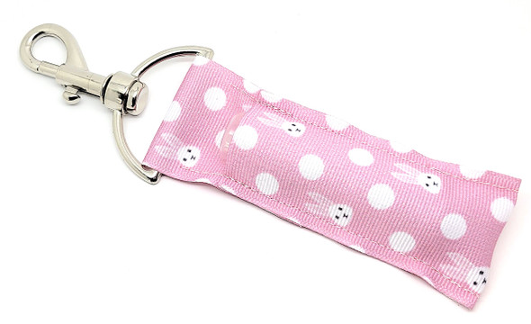 Pretty in Pink Easter Bunny Lip Balm Holder 

Keep your lip balm stylishly secure and festive with our Pretty in Pink Easter Bunny Lip Balm Holder! This charming holder features a soft pink background adorned with adorable white polka dots (that look like fluffy cotton balls!) and playful Easter bunnies. It's the perfect mix of sweet and stylish, making it a must-have for spring and Easter celebrations!

Designed to clip easily onto your keys, purse, backpack, or Easter basket, this lip balm holder ensures you’ll never have to dig around for your favorite balm again. It’s cute, convenient, and the perfect springtime accessory!

Why You’ll Love It
Never Lose Your Lip Balm Again

No more searching for your lip balm! With our secure swivel-head clasp, you can easily attach this holder to keys, bags, lanyards, backpacks, or even Easter baskets to keep your lip balm within reach.

Adorable & Festive Design

The playful bunny and polka dot pattern makes this holder the perfect Easter-themed accessory. Whether for yourself or as a thoughtful Easter gift, this lip balm holder is a fun way to celebrate spring!

Handmade Quality

Proudly handmade in the USA, our lip balm holders are durable, functional, and designed with care to last through every season.

The Perfect Easter Basket Stuffer

Looking for a unique and practical Easter gift? This Pretty in Pink Easter Bunny Lip Balm Holder is a must-have Easter basket filler for:

Easter gifts for Kids, Teens & Adults
Spring Birthdays & Celebrations
Friends, Daughters, Nieces & Teachers
Anyone who loves adorable and functional accessories!

Buy With Confidence

Our Gettin’ Lippy Lip Balm Holders are top-rated for their quality and design. We stand behind our product with a 100% Money-Back Guarantee. If you’re not completely satisfied, we’ll refund your purchase—no questions asked!

Note: Lip balm not included—pair it with our Easter Lip Balm 3-Pack for the ultimate Easter treat!

Handmade in the USA

Order now and give your lip balm the cutest home this Easter!