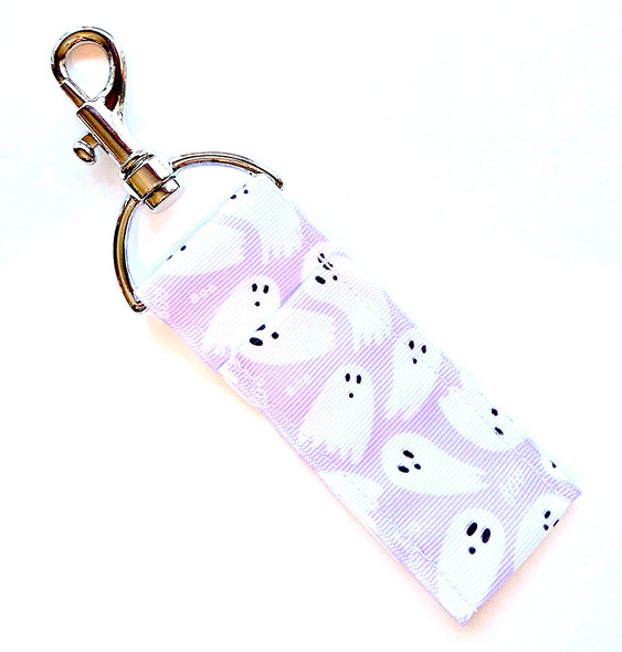 Spooky Chic Purple Ghost Lip Balm Holder

Add a little glam to your ghoul game with our Spooky Chic Purple Ghost Lip Balm Holder! This hauntingly adorable accessory features playful white ghosts floating across a deep purple background—perfect for Halloween lovers who like their spooky style with a dash of charm.

Whether you’re putting together a boo basket, surprising your favorite ghoul-friend, or treating yourself, this purple ghost lip balm holder is the perfect blend of practical and festive flair!

Why You’ll Love It:

Keep Your Lip Balm Handy
Clip it to your keys, purse, backpack, or lanyard and keep your favorite Gettin Lippy balm within reach. No more digging through your bag when your lips need a little love!

Ghostly Gorgeous Design
This purple-and-white ghost pattern brings Halloween spirit to life! It’s a must-have for ghost fans, spooky-season enthusiasts, and anyone who loves cute and functional accessories.

Durable & High-Quality Printed Fabric
Each holder is handmade in the USA using high-quality printed fabric that’s both durable and stylish—designed to last well beyond the Halloween season.

Pairs Perfectly With:
Our Halloween Lip Balms
Gettin Lippy Safety Keychain Wristlets
Whipped & Drench Body Butters
Island Radiance Body Scrub — keep that fall chill from drying you out!

Makes a Great Gift For:

Halloween Boo Baskets

Fall Party Favors

Teen & Teacher Gifts

Spooky Season Collectors

Your best ghoul-friend

Product Details:

Dimensions: 6.5 inches (with hook) x 1.5 inches

Includes: 1 Spooky Chic Purple Ghost Lip Balm Holder

Material: High-quality printed fabric

Lip balm not included — pair it with your favorite Gettin Lippy Halloween Lip Balm Pack for a complete gift set!

Handmade with care in the USA

Limited Edition – Order before these ghosts disappear!
