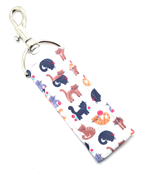 Purr-fectly Adorable – Colorful Cats Lip Balm Holder Keychain

Calling all cat moms, cat dads, and anyone who can’t resist a little feline mischief — the Purr-fectly Adorable Lip Balm Holder is here to make your chapstick the cat’s meow.

This charming lip balm holder features a cream-colored background sprinkled with playful cats in orange, brown, black, and grey, each one cute, curious, and full of personality. Whether your heart belongs to tabbies, calicos, or tuxedos, this holder is the perfect way to carry a little cat cuteness wherever you go.

Clip it onto your keys, backpack, purse, or lanyard for easy access to your lip balm and an instant dose of feline fun!

Why You’ll Love It

Playful Cat Design – Adorable orange, brown, black, and grey cats on a cream background

Cat Lover Approved – Perfect for cat moms, cat dads, and anyone obsessed with whiskers and paws

Keep Lip Balm Handy – Swivel clasp keeps your chapstick secure and within reach

Cute + Functional – A purr-fect accessory for everyday style

Product Details

Size: Approx. 6.5" x 1.5"

Material: High-quality printed fabric

Includes: 1 Purr-fectly Adorable lip balm holder (lip balm not included)

Handcrafted in the USA