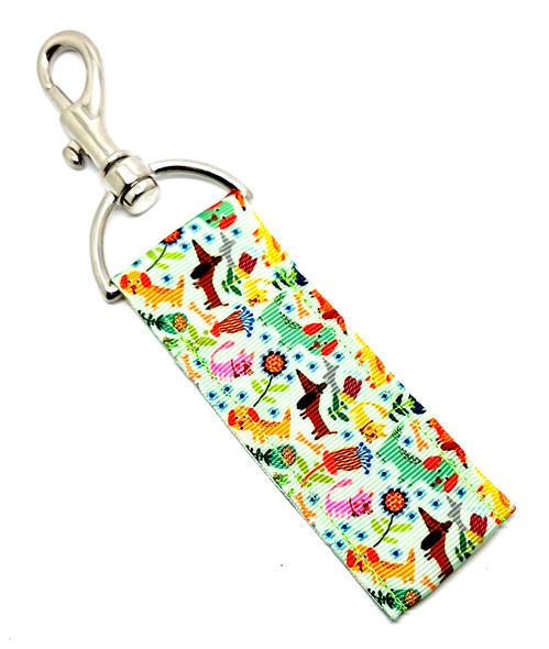 Flower Pup Frenzy – Colorful Dogs & Blooms Lip Balm Holder

A little floral, a lot of puppy love — the Flower Pup Frenzy Lip Balm Holder is the perfect accessory for anyone who wants a cheerful pop of color and adorable dog energy wherever they go!

This design features a light green background sprinkled with playful dogs in orange, brown, pink, yellow, and green, all surrounded by sweet, whimsical flowers. It’s bright, charming, and guaranteed to make you smile every time you grab your chapstick.

Clip it to your keys, purse, backpack, dog-walking bag, or lanyard, and keep your lip balm handy while rocking the cutest dog-themed accessory ever.

Why You’ll Love It

Colorful Dog + Floral Design – A lively mix of pastel pups and blooms on a soft green background

Perfect for Dog Lovers – Great for dog moms, pet parents, walkers, sitters, and groomers

Never Lose Your Chapstick Again – Swivel clasp keeps it secure, upright, and easy to reach

Fun + Functional – Cute enough to show off, durable enough for everyday use

Product Details

Size: Approx. 6.5" x 1.5"

Material: High-quality printed fabric

Includes: 1 Flower Pup Frenzy lip balm holder (lip balm not included)

Handcrafted in the USA