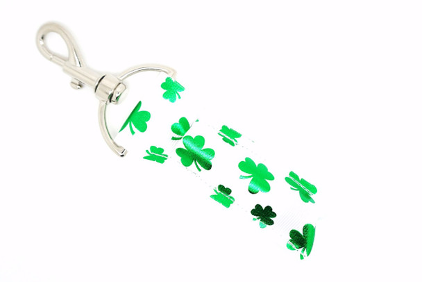 Shamrock Shine Lippy Clip - Green Foil Shamrock Lip Balm Holder

Celebrate the luck of the Irish in sparkling style with Shamrock Shine – a dazzling lip balm holder featuring a white background sprinkled with medium and small shiny green foil shamrocks. This festive design brings shimmer, charm, and functionality to your everyday essentials.

Perfect for St. Patrick’s Day celebrations or anyone who loves to add a little sparkle and luck to their routine!

Why You’ll Love It:
Gorgeous green foil shamrocks for eye-catching shine
Clips easily to your keys, purse, backpack, or lanyard
Keeps your lip balm secure and easy to access
Great gift for friends, teachers, or party favors
Handmade with high-quality printed fabric for durability and sparkle
Product Details:

Design: White background with shiny green foil shamrocks (medium and small sizes)

Material: Durable, high-quality printed fabric

Clip: Strong silver lobster clasp

Size: Fits standard lip balm tubes

Includes: 1 Shamrock Shine lip balm holder (lip balm not included)

Handmade by Gettin Lippy in the USA