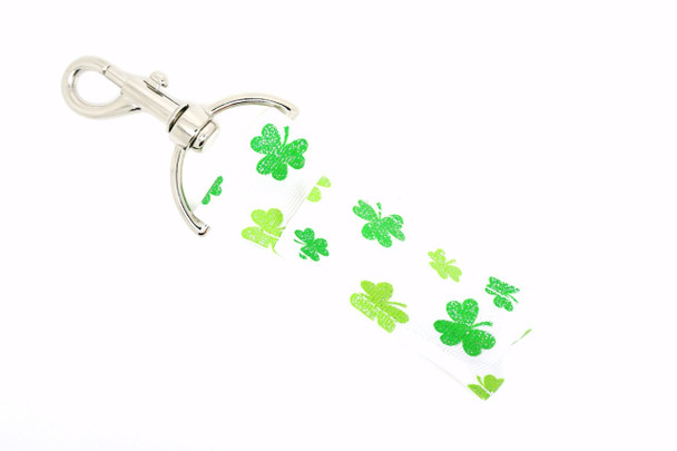 Lucky Little Things Lippy Clip - Glitter Shamrock Lip Balm Holder

Keep your lips lucky and your balm close with Lucky Little Things – a sparkling St. Patrick’s Day-themed lip balm holder featuring a crisp white background adorned with light green and green glitter shamrocks in various sizes scattered in a playful pattern.

Whether you're heading to a parade, a party, or just living your lucky life, this festive and functional lippy clip will have you feeling charmed all day long!

Why You’ll Love It:
Random pattern of glittery shamrocks for a fun, festive look
Easy to clip onto keys, backpacks, bags, or belt loops
Keeps your favorite lip balm easy to access
Makes a perfect St. Paddy’s Day gift or seasonal accessory
Handmade with high-quality printed fabric for lasting sparkle
Product Details:

Design: White background with medium and small glitter shamrocks in green and light green

Material: Durable, high-quality printed fabric

Clip: Secure silver lobster clasp

Size: Fits standard lip balm tubes

Includes: 1 Lucky Little Things lip balm holder (lip balm not included)

Handmade by Gettin Lippy in the USA
