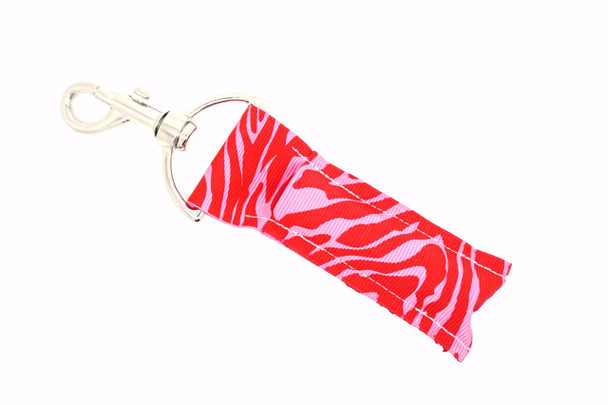 Wild Crush - Pink and Red Zebra Lip Balm Holder Lippy Clip

Fierce meets flirty with Wild Crush – your new favorite lip balm holder from Gettin Lippy! Featuring a bold pink and red zebra stripe design, this vibrant and playful lippy clip adds a wild pop of color and sass to your everyday essentials. Whether you’re headed to class, work, or girls’ night out, this glam accessory keeps your favorite lip balm handy and stylish.

Perfect for Valentine’s vibes, bold fashionistas, or anyone who loves a splash of wild fun!

Why You’ll Love It:

Bold pink & red zebra stripes make a fashion-forward statement
Easy-to-use silver clasp for clipping to keys, bags, or backpacks
Holds most standard lip balms, lip glosses, and roller bottles
Fun gift for tweens, teens, moms, and beauty lovers
Great for Valentine's Day, stocking stuffers, or cheer bags

Product Details:

Design: Pink and red zebra stripe

Material: High-quality printed fabric

Clip: Silver lobster clasp for quick attachment

Size: Fits most standard-size lip balms and gloss tubes

Includes: 1 Wild Crush lip balm holder (lip balm not included)

Handmade with flair by Gettin Lippy in the USA