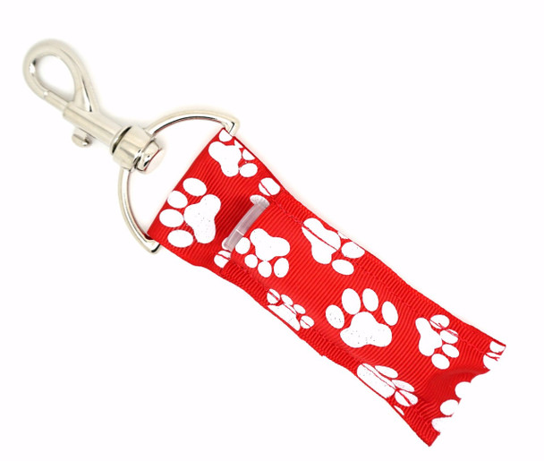 Pawfect Sparkle – Red & White Glitter Paw Print Lippy Clip Keychain

Show off your pet love in style with the Pawfect Sparkle! This vibrant lip balm holder features a bold red background with glittery white paw prints, perfect for dog moms, animal lovers, or anyone who believes fur babies deserve the spotlight.

Designed to clip onto your keys, bag, or leash, this cute and functional lippy clip keeps your favorite lip balm within paw’s reach wherever you go.

Why You’ll Love It:

Bright Red Background – Bold and beautiful to stand out
White Glitter Paw Prints – Sparkly and playful detail for pet lovers
Clip-On Convenience – Easily attaches to keychains, backpacks, leashes & more
Lip Balm Ready – Designed to hold standard lip balm or essential oil rollers
Perfect Gift – For pet moms, vet techs, groomers, or animal shelter heroes

Product Details:

Design: Red background with glitter white paw prints

Material: High-quality printed fabric

Clip: Durable lobster clasp keyring

Size: Fits most lip balm brands

Includes: 1 Pawfect Sparkle lip balm holder (lip balm not included)

Handmade by Gettin Lippy with love & flair in the USA