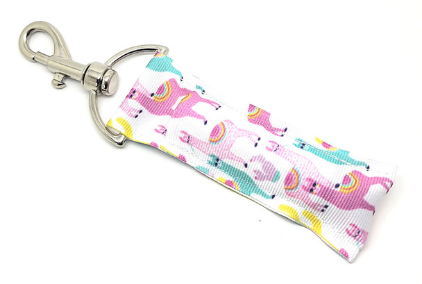 Llama Mama Pastel Llama Lip Balm Holder

Say hello to sweet and sassy with the Llama Mama Lip Balm Holder! This charming design features pastel-colored llamas adorned with cute accessories — all set against a clean white background for a bright and cheerful vibe.

Whether you're a llama lover or just looking for a fun and functional way to carry your favorite balm, Llama Mama brings personality, practicality, and plenty of charm to your keychain, purse, or backpack!

Why You'll Love It:

Never Lose Your Lip Balm Again
Keep your balm handy wherever you go with the secure swivel clasp that attaches easily to your bag, keyring, or belt loop.

Adorably Unique Design
Cute pastel llamas (some with glasses and hats!) on a crisp white background make this holder as fun as it is fashionable.

Perfect for All Ages
Ideal for llama fans, teens, kids, teachers — or anyone who loves a little whimsy in their everyday essentials.

Handmade with Love
Crafted in the USA from high-quality woven fabric and sturdy hardware to ensure lasting use and enjoyment.

A Gift That Gets a Smile
Looking for a fun, thoughtful, and practical gift? Llama Mama is perfect for:

Birthday party favors

Teacher appreciation gifts

Stocking stuffers

Just-because surprises

Easter basket treats

100% Satisfaction Guarantee
We back every product we make. If you're not absolutely delighted, we'll make it right — no questions asked!

Product Details:

Size: 6.5 inches (including clasp) x 1.5 inches

Material: Durable woven fabric with premium hardware

Includes: 1 Llama Mama Lip Balm Holder

Note: Lip balm not included — pair it with a Gettin’ Lippy balm!

Handmade in the USA
