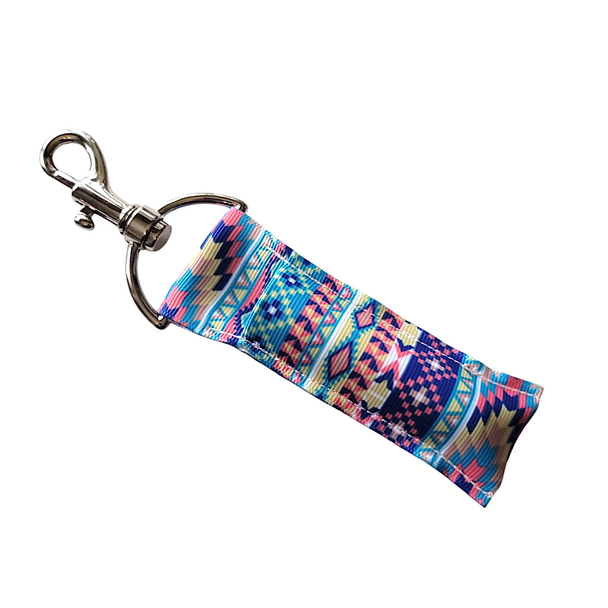 Desert Sky Southwest Lip Balm Holder

Bring the beauty of the open desert skies wherever you go with our Desert Sky Southwest Lip Balm Holder!
This vibrant design features gorgeous shades of blue, pink, tan, brown, and white — woven into stunning southwest patterns that feel both timeless and trendy. It's the perfect mix of bold colors and intricate southwestern artistry!

Designed to easily clip onto your keys, backpack, purse, or lanyard, this lip balm holder keeps your favorite balm stylishly secure and always within reach.

Why You'll Love It:

Never Lose Your Lip Balm Again
Tired of losing track of your favorite balm? Our secure swivel-head clasp makes it simple to keep your lip balm close at all times — just clip and go!

Bold, Southwest Style
The Desert Sky pattern brings a splash of vibrant, bohemian charm to your everyday essentials. A stylish reminder of wide-open spaces, colorful sunsets, and cozy desert vibes.

Handmade Quality
Proudly handmade in the USA, each holder is crafted with care for lasting durability and beauty.

Perfect Gift Idea
Looking for a unique and practical gift? The Desert Sky Southwest Lip Balm Holder is ideal for:

Birthday gifts

Southwest-themed parties

Graduations

Stocking stuffers

Anyone who loves the southwest style!

Buy With Confidence
At Gettin’ Lippy, we stand behind our products with a 100% Money-Back Guarantee. Love it or your money back — no questions asked.

Product Details:

Dimensions: 6.5 inches (with hook) x 1.5 inches

Package Includes: 1 Desert Sky Southwest Lip Balm/Chapstick Holder

Note: Lip balm not included — browse our Gettin’ Lippy collection for the perfect balm to match!

Handmade with love in the USA