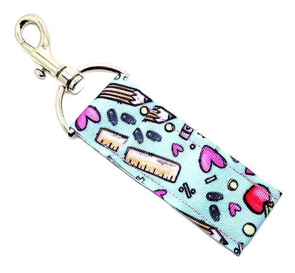 “Mint to Teach” – Teachers Lip Balm Holder

Fresh, fun, and full of teacher pride — our “Mint to Teach” Lip Balm Holder is the perfect classroom companion for every educator who deserves a little daily pampering!

This adorable design features a mint-green background covered in cute doodles of rulers, apples, hearts, and paper clips, celebrating all the little details that make teaching so special. Clip it to your keys, lanyard, tote, or teacher badge and keep your favorite Gettin Lippy balm close at hand for smooth, hydrated lips through every lesson, lunch duty, and late-night grading session!

Because every great teacher deserves great lips! 

Why You’ll Love It

Cute Teacher-Inspired Design:
Whimsical school doodles on a mint background — the perfect mix of sweet, smart, and stylish!

High-Quality Printed Fabric:
Durable, soft, and vibrant to handle every hectic school day.

No More Lost Lip Balm:
Swivel clasp easily attaches to a lanyard, backpack, or bag — so your lip balm stays where you need it.

Perfect Teacher Gift:
An affordable and adorable gift for teachers, aides, or educators who could use a little self-care between bells.

Handmade in the USA:
Each piece is crafted with love and attention to detail — teacher-approved quality you can trust!

Perfect For:

Teachers, aides, and school staff

Back-to-school gifts

Teacher appreciation week

Fun, functional classroom accessories

Anyone who loves mint-green and motivational charm!

Product Details

Dimensions: 6.5 inches (with hook) x 1.5 inches

Includes: 1 Lip Balm Holder (lip balm not included)

Material: High-quality printed fabric

Handmade in the USA

Pair it with your favorite Gettin Lippy lip balm, keychain wristlet, or body care goodies for the full Mint to Teach experience!