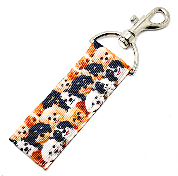 Puppy Love Parade – Cute Dog Face Lip Balm Holder Keychain

Calling all dog moms, dog dads, and anyone whose camera roll is 98% puppy pics — the Puppy Love Parade Lip Balm Holder is about to steal your heart and your lip balm (just kidding… it only holds it).

Covered in a crowd of the cutest little puppy faces — in white, cream, tan, brown, and black — this lip balm holder is basically a pocket-sized puppy party. Whether you’re obsessed with all breeds or just appreciate adorable doggie expressions, this keychain brings instant joy and keeps your chapstick exactly where you need it.

Clip it on your keys, leash bag, purse, or backpack and let the puppy cuteness follow you everywhere!

Why You’ll Love It

All the Puppy Faces – A mix of sweet, smiling pups in every shade of adorable

Dog Lover Approved – Perfect for dog moms, pet sitters, groomers, walkers, and pup-obsessed humans

Convenience You’ll Actually Use – Never lose your chapstick at the bottom of your bag again

Cute + Functional – A must-have accessory for both style and practicality

Product Details

Size: Approx. 6.5" x 1.5"

Material: High-quality printed fabric

Includes: 1 puppy-face lip balm holder (lip balm not included)

Handcrafted in the USA