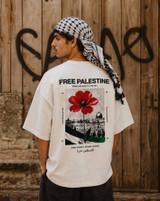 Icy Rock oversized t-shirt back print reading Free Palestine From The River To The Sea, with a red poppy hannoun flower over a halftone illustration of Jerusalem's Old City and Dome of the Rock, Palestinian flag colours, and Land People History Rights tagline