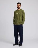 Olive green long sleeve t-shirt with "From My Eyes" in Arabic and English on the chest, hand-drawn eye and vine motif on the left sleeve, and Toronto Palestine Film Festival wordmark on the right sleeve
