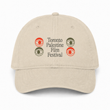 Stone/khaki dad hat with the Toronto Palestine Film Festival wordmark in black, flanked by two red and two olive eye motifs, front view