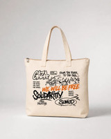 Close-up flat-lay of the Sumud Graffiti Tote Bag showing the full graffiti-style print detail including Gaza, Solidaritty, Sumud, and Free Palestine text