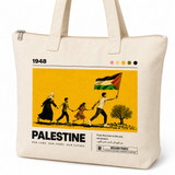 Close-up of 1948 Palestine tote bag graphic showing family figures, flag, and olive branch illustration on natural canvas