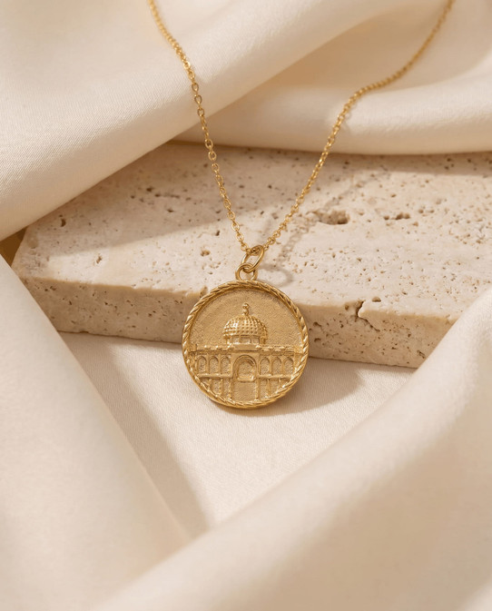 Close-up of the gold Dome of the Rock heritage necklace pendant