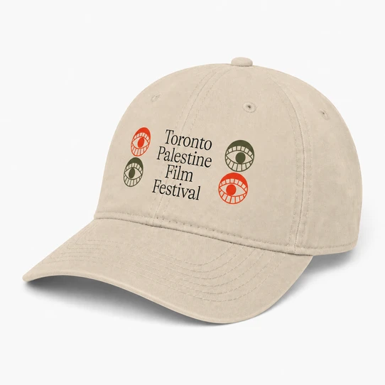 Stone/khaki dad hat with the Toronto Palestine Film Festival wordmark and red and olive eye motifs, angled view showing pre-curved visor with navy undervisor