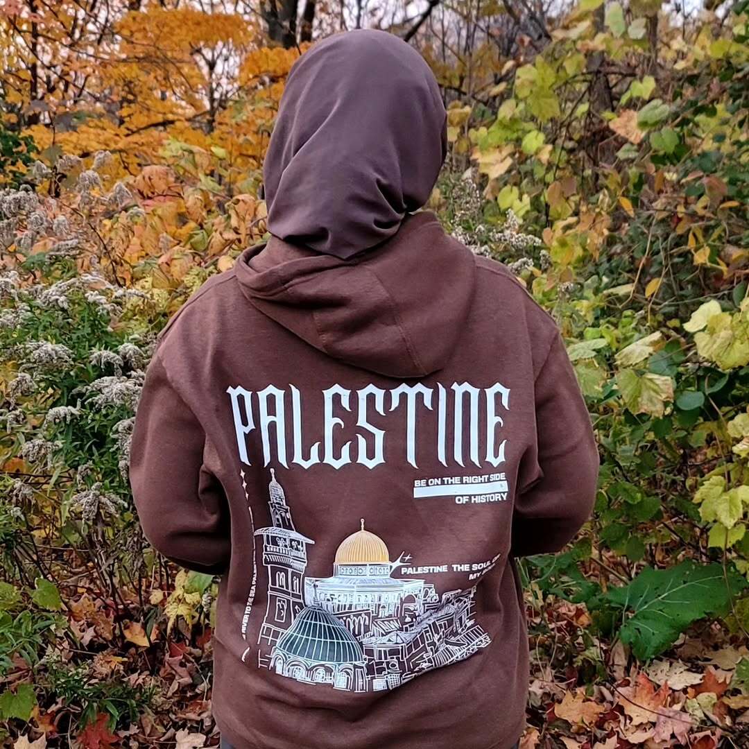 Customer wearing Palestine hoodie in forest
