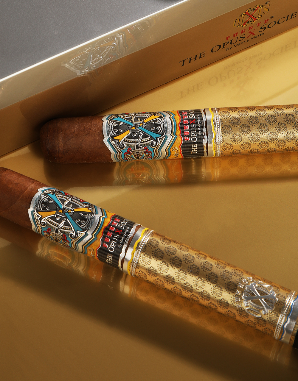 Fuente Fuente Opus X Society Gold & Bullet Single Cigars laying on box lid