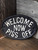 WELCOME NOW PISS OFF Cast Iron Sign