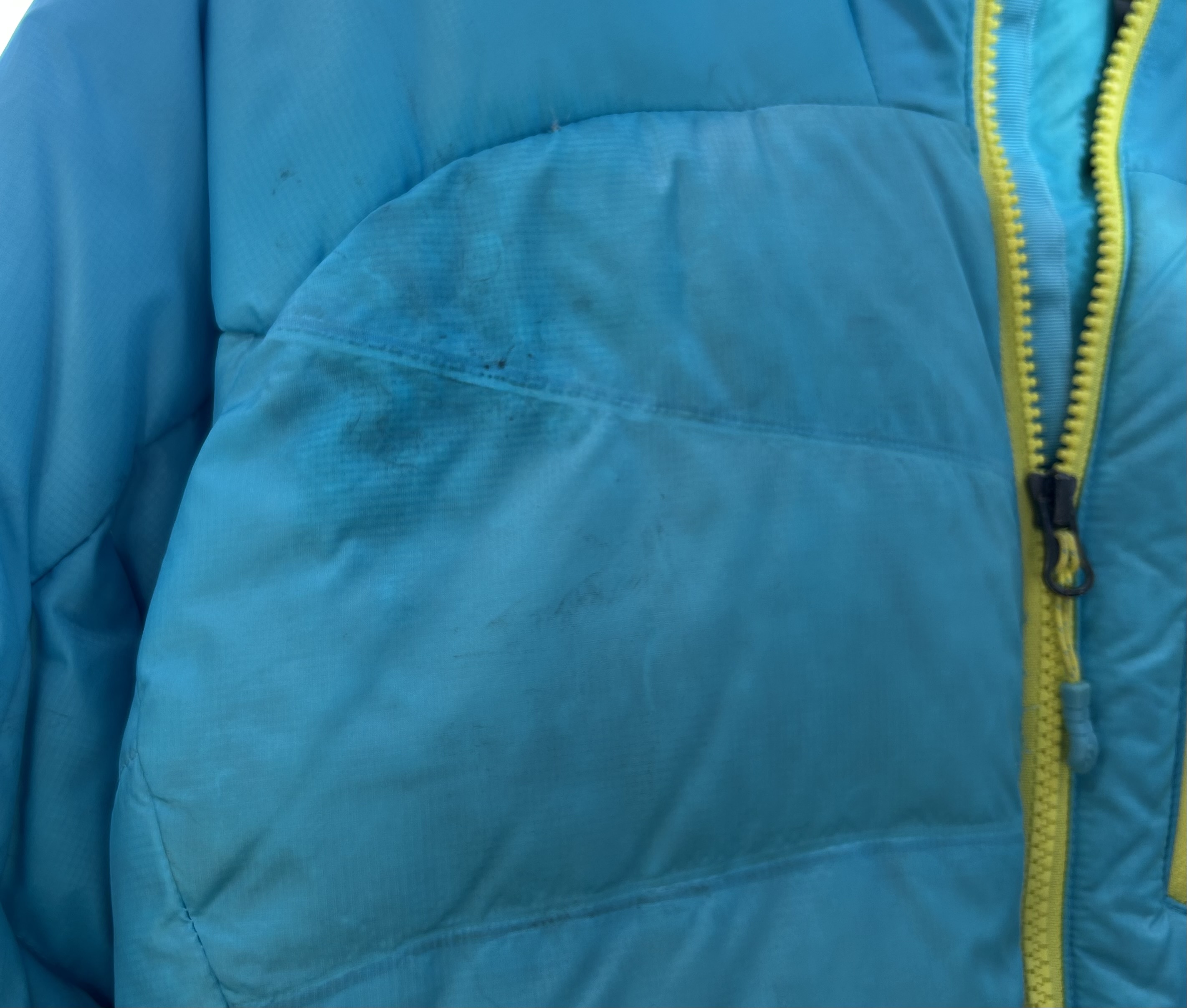 small stain and feather hole on right chest
