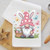 Close-up of Easter bunny gnome kitchen towel — pink hat, flower basket, pastel spring colors on white waffle weave dish towel