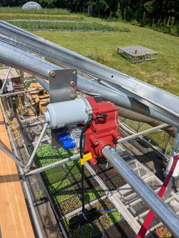 Ridge vent motor installed on greenhouse bow in a working greenhouse