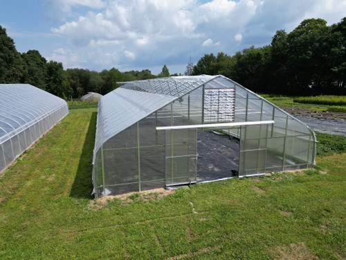 poly film greenhouse with rack and pinion ridge vent system installed
