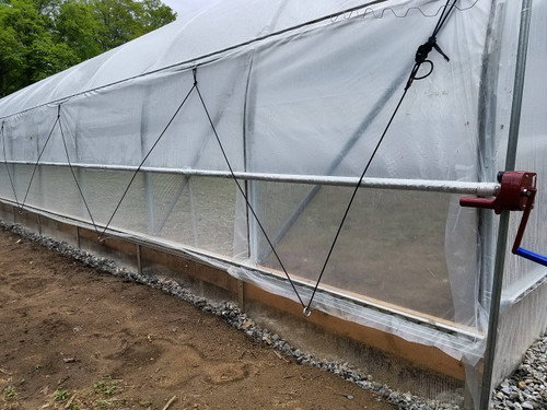 greenhouse with roll up side ventilation system installed