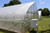Outdoor mounted ThermaGrow heaters on high tunnel greenhouses
