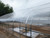 Aluminum Base and Cap to Secure Polycarbonate sheet over curved roof profiles.