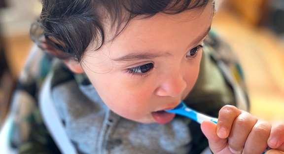 Toddler eating from spoon