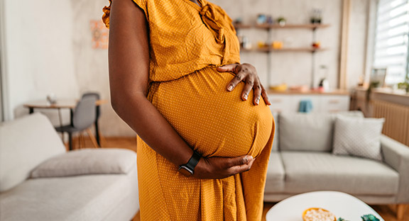 Pregnant mother with hands on stomach