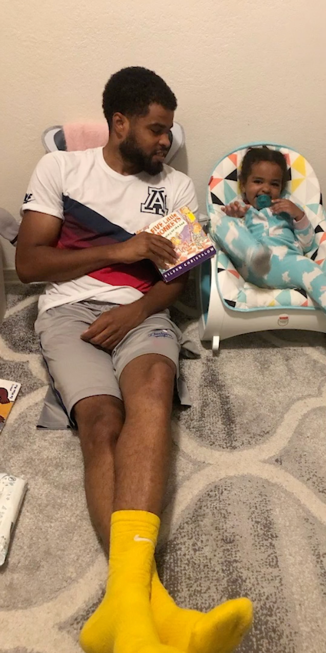 Father and daugther with a book playing