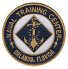 A round Naval Training Center Orlando patch with a gold merrowed border and navy blue field, NAVAL TRAINING CENTER arched above and ORLANDO, FLORIDA below in gold, a gold fouled anchor on a navy diamond at the center.