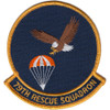 Circular embroidered patch with navy blue field, gold border, bald eagle in diving attitude toward an orange and white parachute, and "79TH RESCUE SQUADRON" gold scroll at bottom.