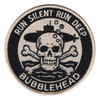 Round black and tan patch with a submarine riding above a skull and crossbones, bubbles rising from the skull, Run Silent Run Deep across the top and Bubblehead below.