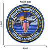 Size Round 4-inch Operation Southern Spear embroidered patch showing a combat dagger with American flag shield guard flanked by two aircraft carriers underway, jet aircraft airborne, and a fast attack craft in the foreground, with gold merrowed border and the motto Vigilance & Vengeance on a deep blue field.