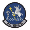 Circular embroidered patch with royal blue field, dark border, white Pegasus rearing on right, gray seahorse on left, yellow lightning bolt connecting them, blue water waves at base, and "129th Rescue SQ" scroll at bottom.