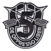 Black and white 5th Special Forces Group crest patch with crossed arrows, an upright dagger and a large black numeral 5 above a DE OPPRESSO LIBER scroll, cut to the crest outline.